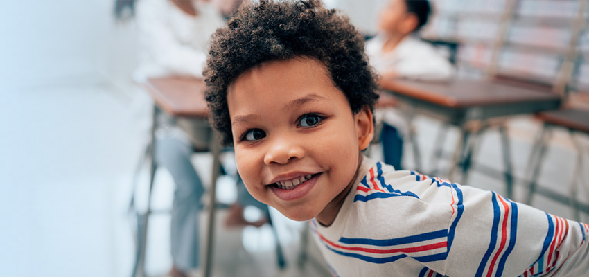 Smiling boy in classroom setting