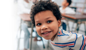 Smiling boy in classroom setting